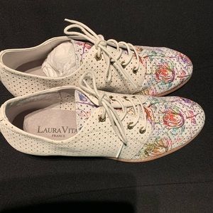 White leather shoes with painted flowers.